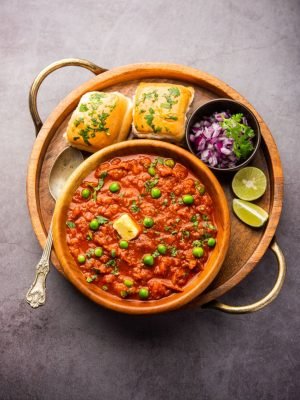 Pav bhaji is a fast food dish from India consisting of a thick vegetable curry served with a soft bread roll