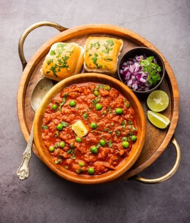 Pav bhaji is a fast food dish from India consisting of a thick vegetable curry served with a soft bread roll